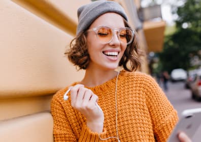 Girl with phone and headphones in her hand